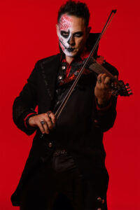 Vitera in costume playing a violin